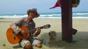 Musician with dog on the beach!