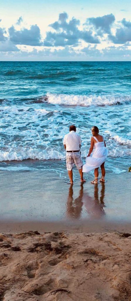 Beautiful Carribean sea with man and woman at water's edge